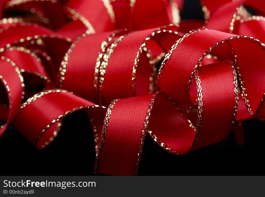 Red ribbon macro on black background. Red ribbon macro on black background