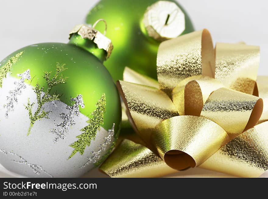 Green and gold christmas bulb and bow scene