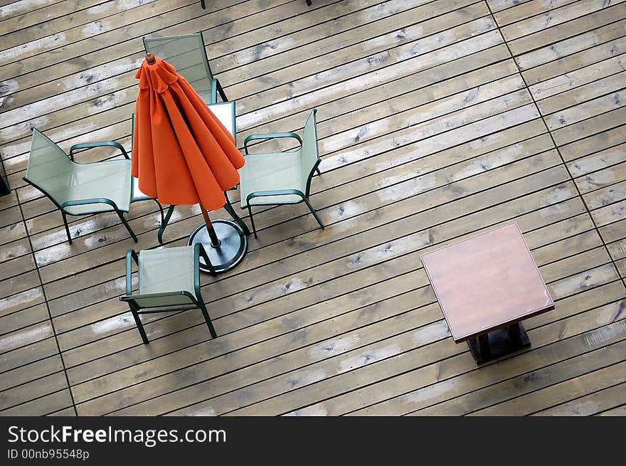 A umbrella, table and chairs in a hotel.