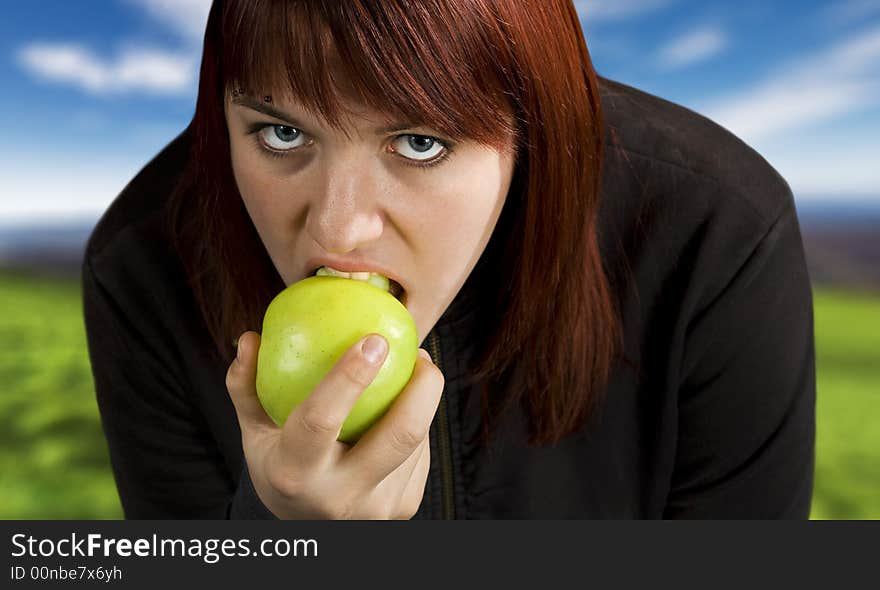 Redhead girl biting on a delicious green apple with a flirtatious look.

Shot in studio. Redhead girl biting on a delicious green apple with a flirtatious look.

Shot in studio.