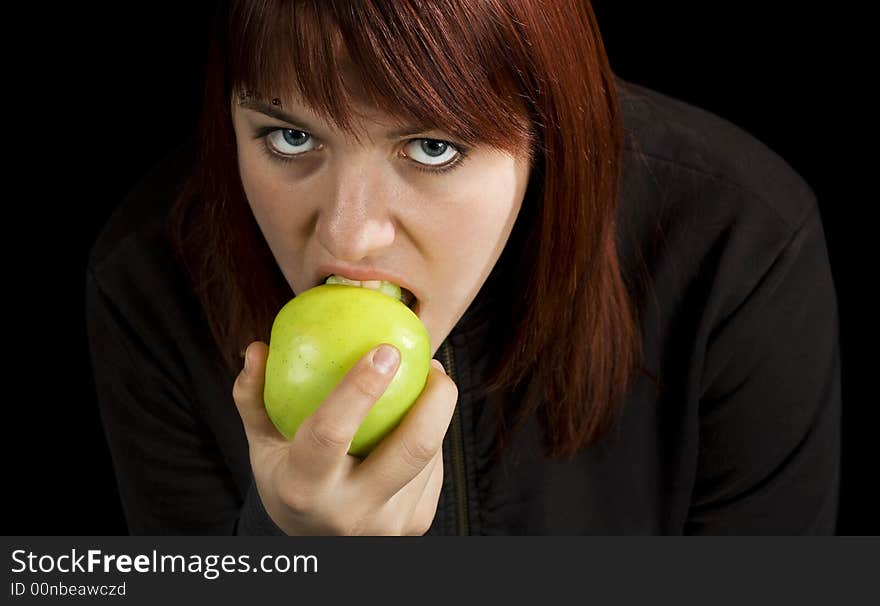 Redhead girl biting on a delicious green apple with a flirtatious look.

Shot in studio. Redhead girl biting on a delicious green apple with a flirtatious look.

Shot in studio.