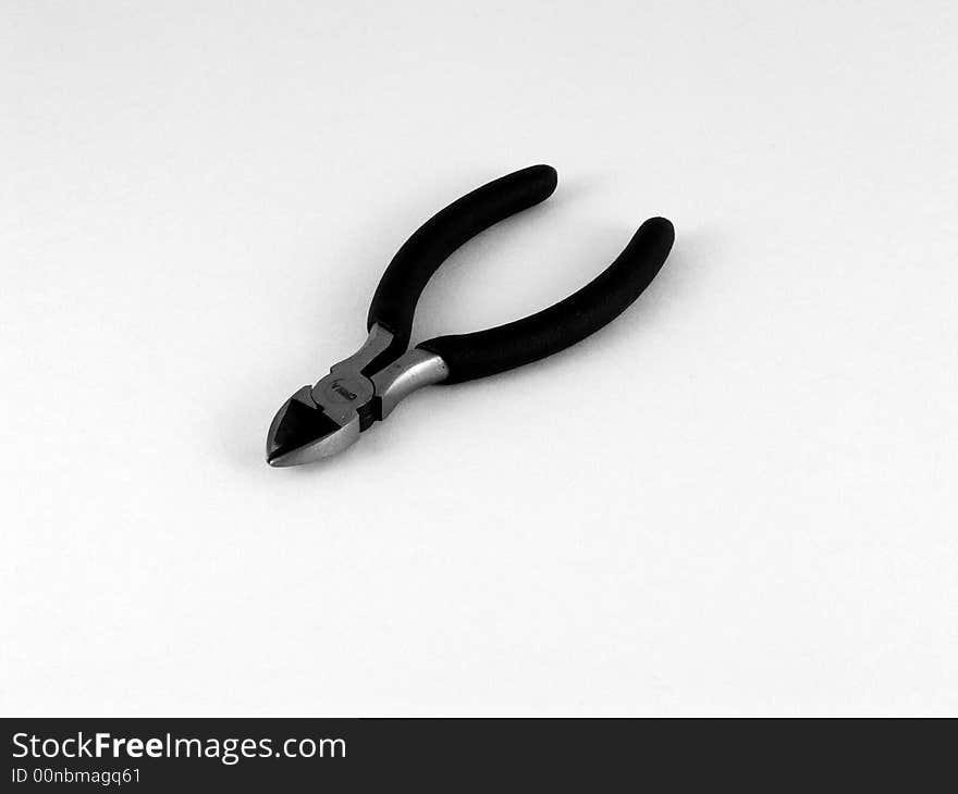 A black and white photo of a wire cutting tool. A black and white photo of a wire cutting tool.