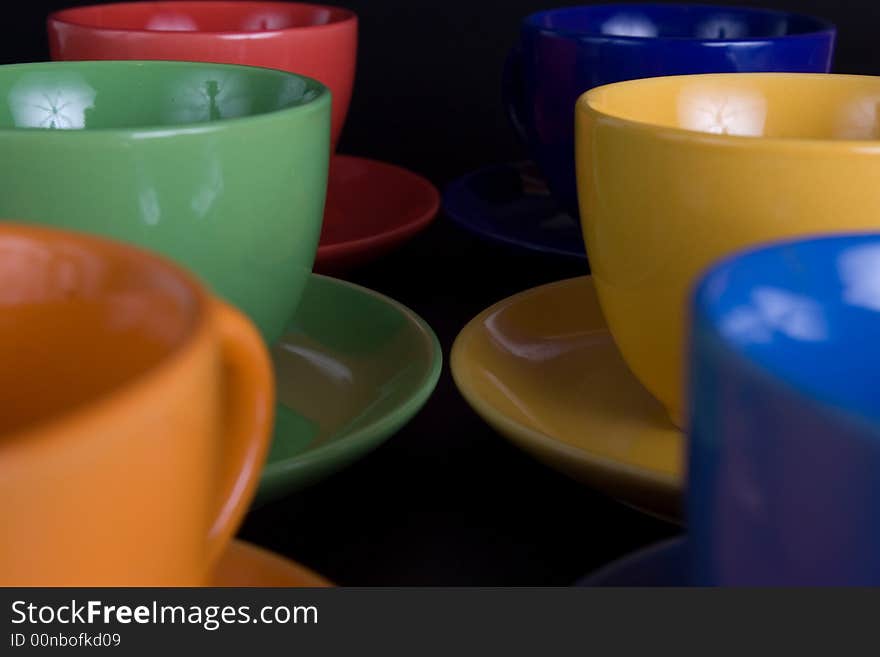 Six color cups on black background