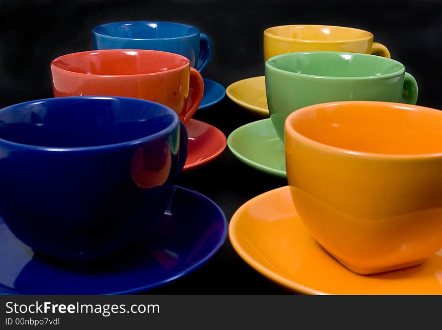 Six color cups on black background