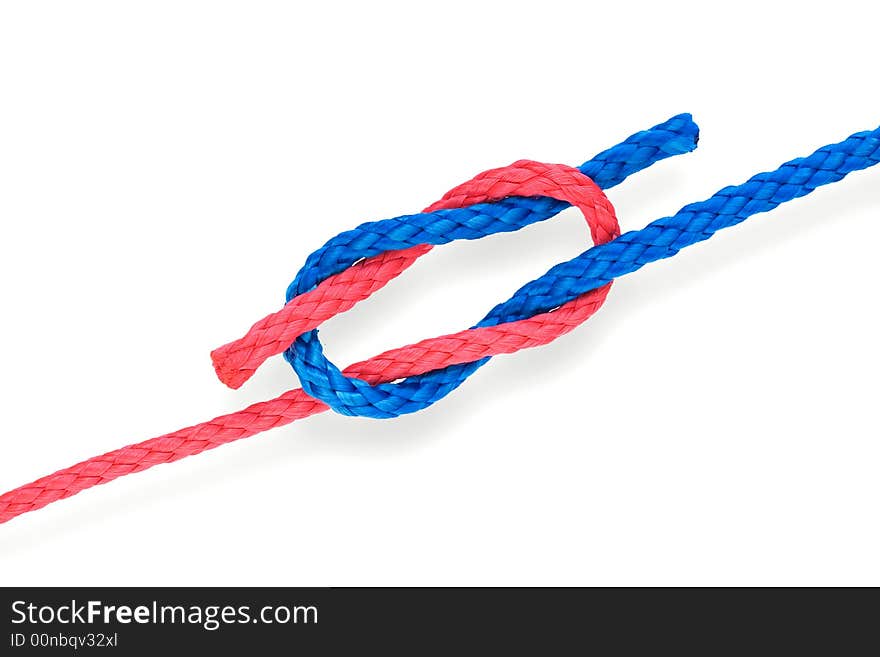 Fisher's granny(bad reef) knot with red and blue ropes. Isolated on white. Fisher's granny(bad reef) knot with red and blue ropes. Isolated on white.