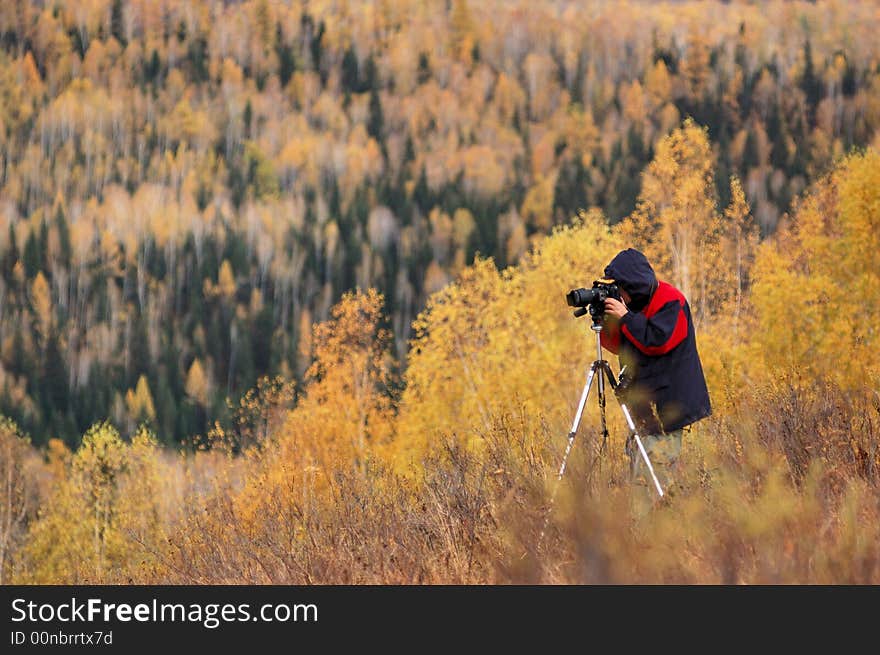 A photographer at work Hemu village, Xinjiang China October, 2007