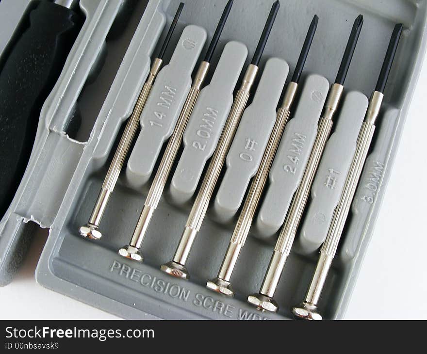 Precision screwdrivers in a plastic case against a white background. Precision screwdrivers in a plastic case against a white background.