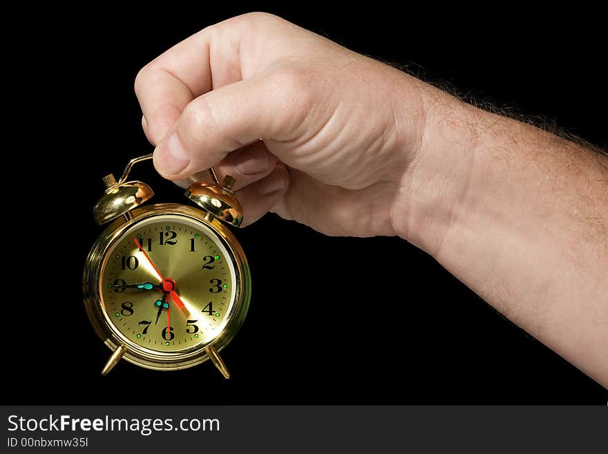 Alarm clock in a hand. Black background. The concept of time. Alarm clock in a hand. Black background. The concept of time.