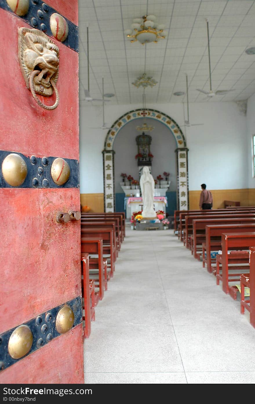 A built in the 15th century old church, With a chinese traditional door.China. A built in the 15th century old church, With a chinese traditional door.China