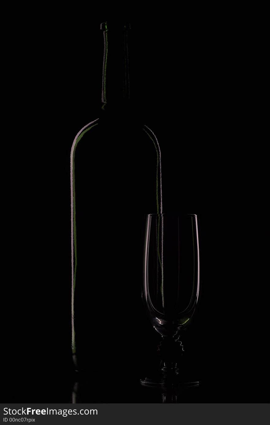 Bottle blame and empty goblet on black background. Bottle blame and empty goblet on black background