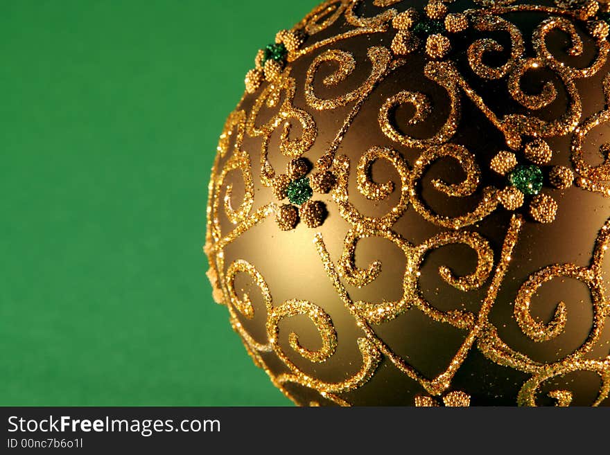 Christmas balls with gold ornaments on the green background. Christmas balls with gold ornaments on the green background