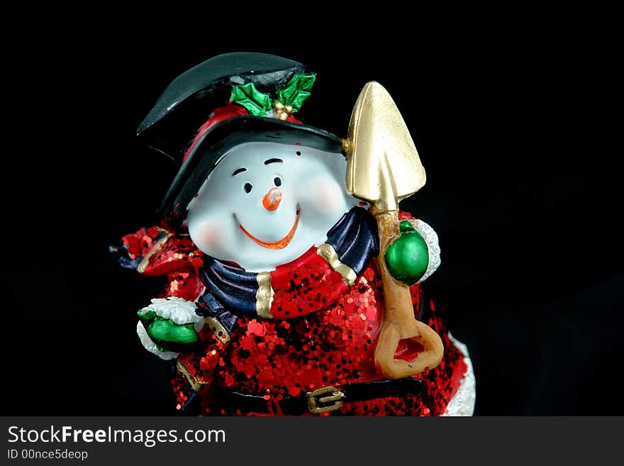 A picture of a snow santa with big smile and shovel