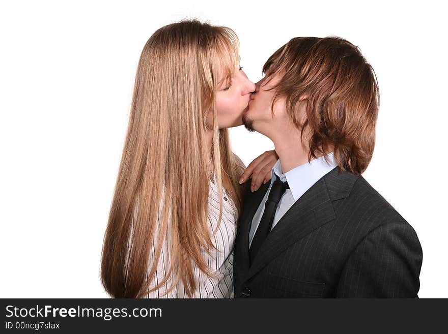 Young kissing couple on a white