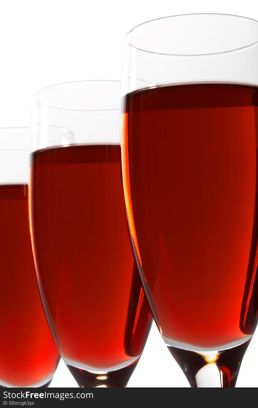 Three glasses with red wine on a white background