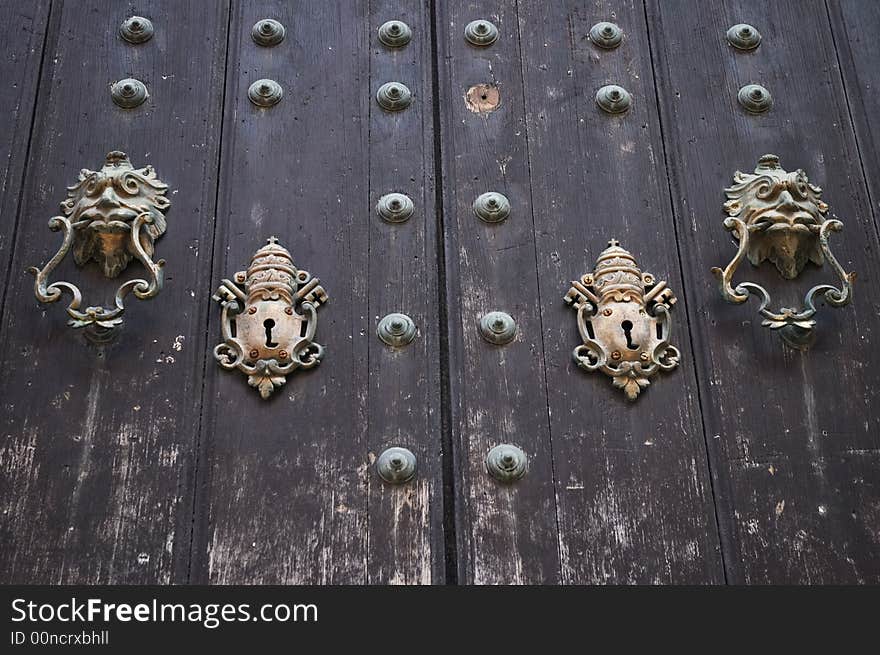 Colonial door with vintage locks and lion doorbell. Colonial door with vintage locks and lion doorbell