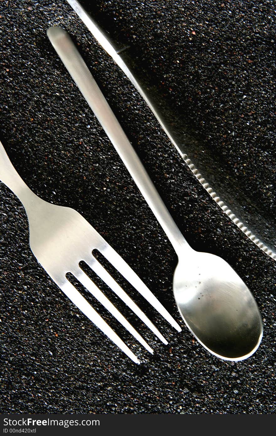 Spoon, Knife and Fork isolated in dark