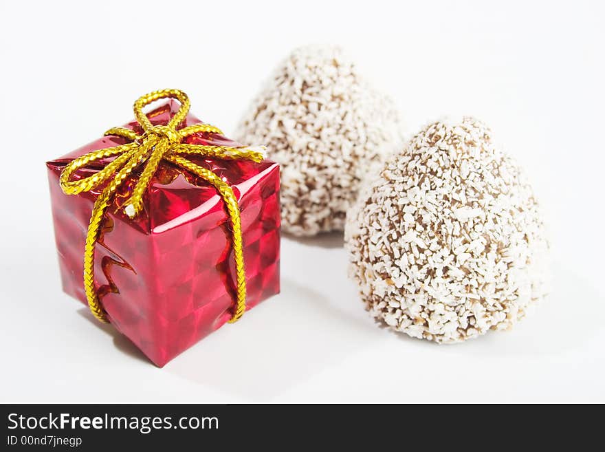 Gift and sweets on white background