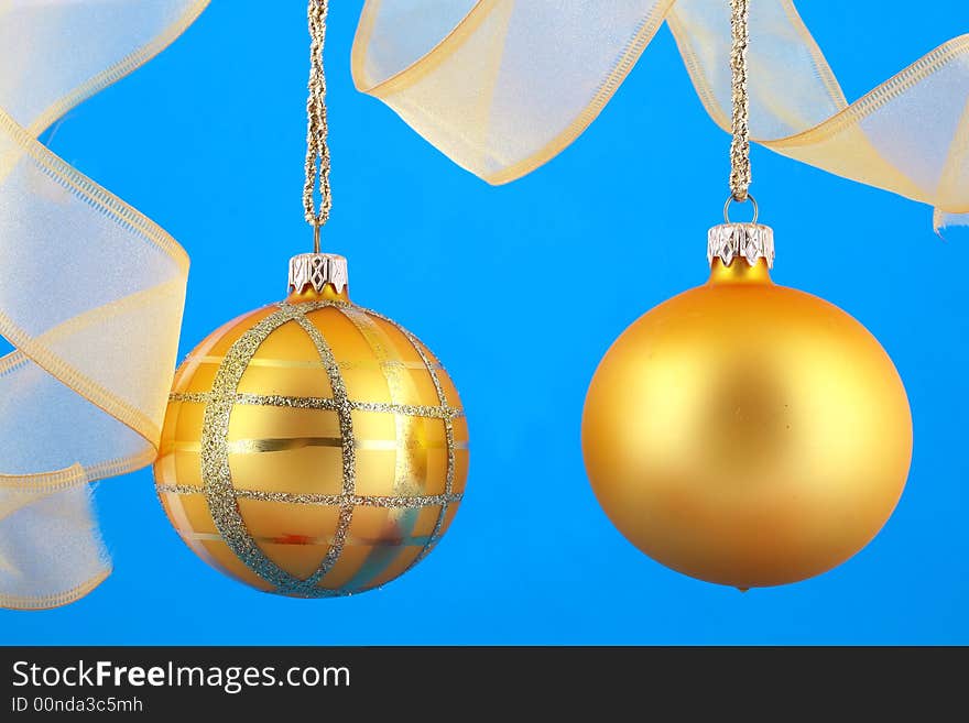 Golden decorative Christmas bauble isolated on blue backgrund. Golden decorative Christmas bauble isolated on blue backgrund