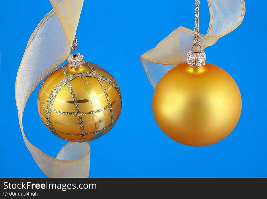 Golden decorative Christmas bauble isolated on blue backgrund. Golden decorative Christmas bauble isolated on blue backgrund