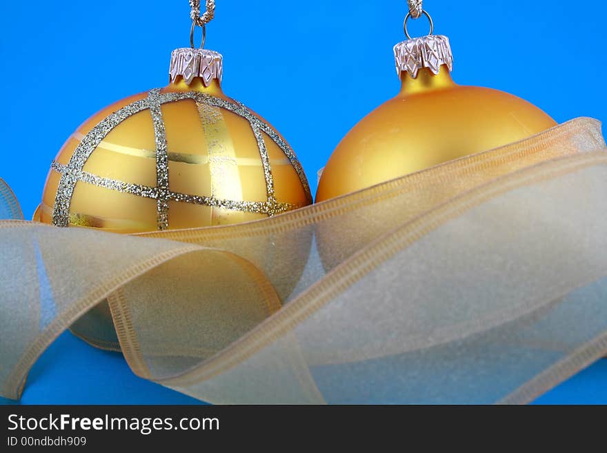 Golden decorative Christmas bauble isolated on blue backgrund. Golden decorative Christmas bauble isolated on blue backgrund