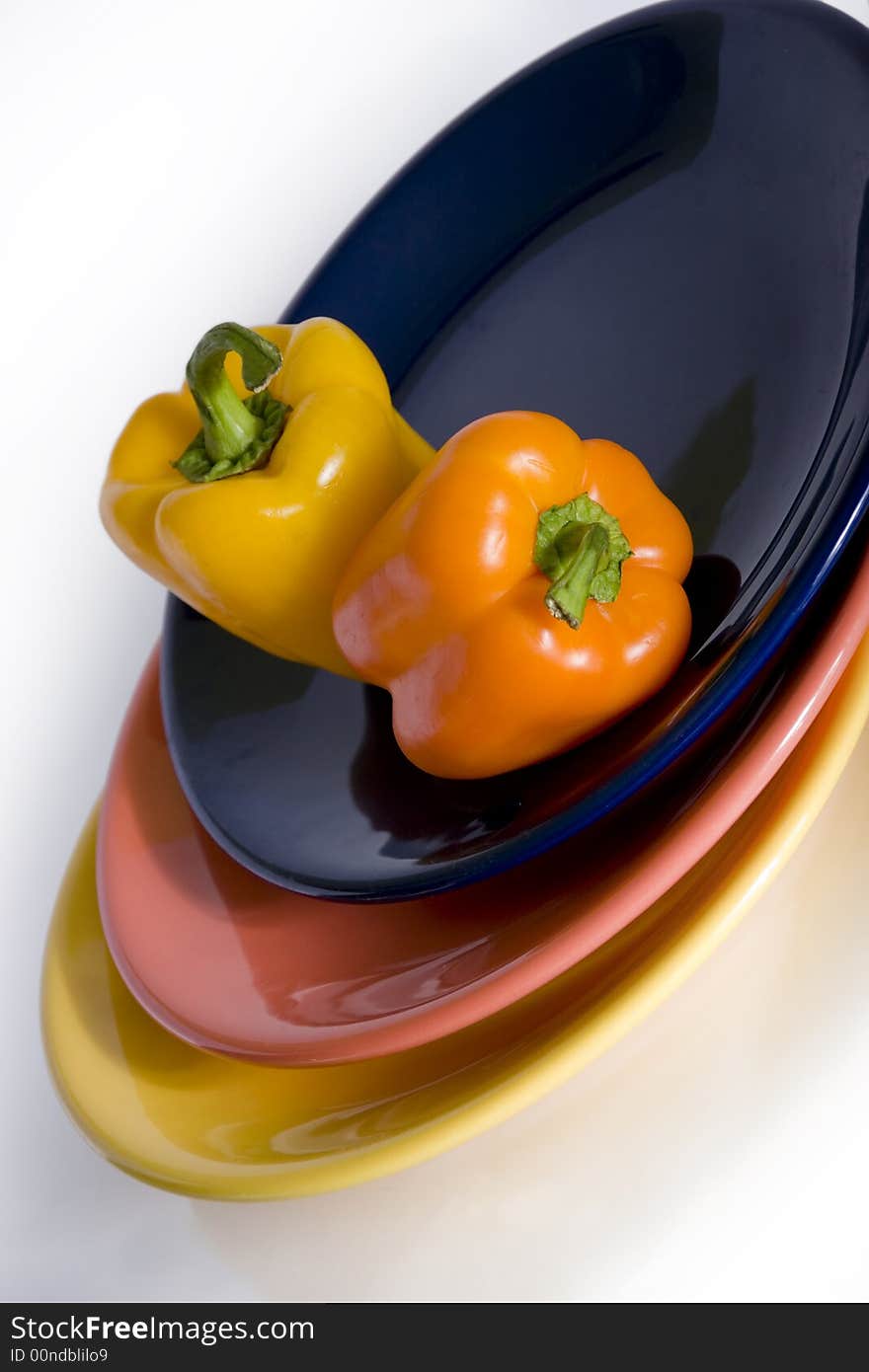 Two peppers in different colour plates