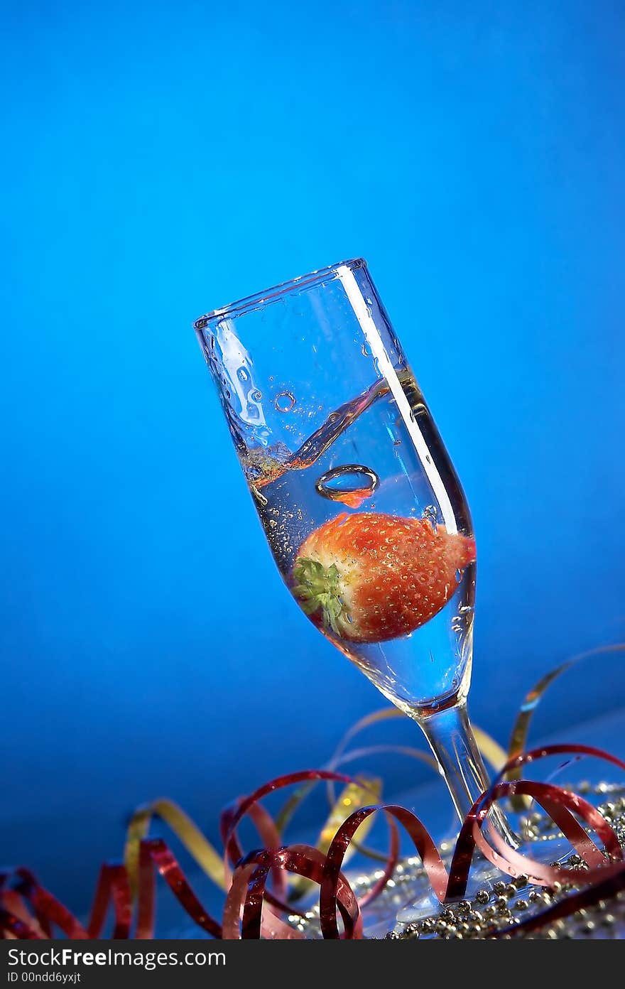 Still life with glass with champagne on the blue background