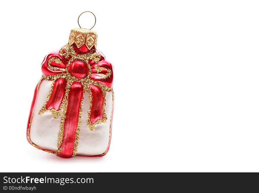 Close-up shot of pretty Christmas decoration in the form of present on white background with copy space at right. Close-up shot of pretty Christmas decoration in the form of present on white background with copy space at right