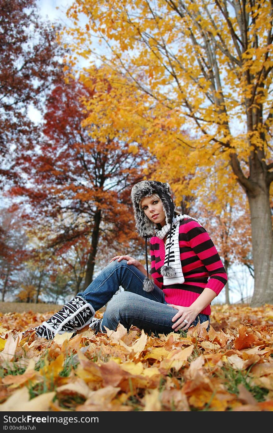 Beautiful girl on a fall day on a vertical format