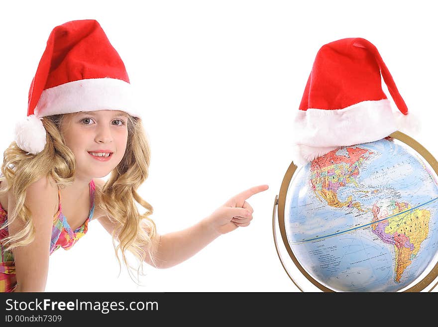 Photo of a Happy little Santa girl pointing at Globe