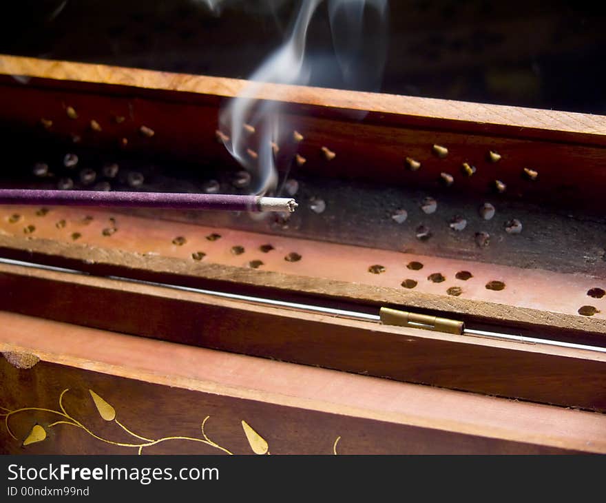 Closeup of an incense stick smoking