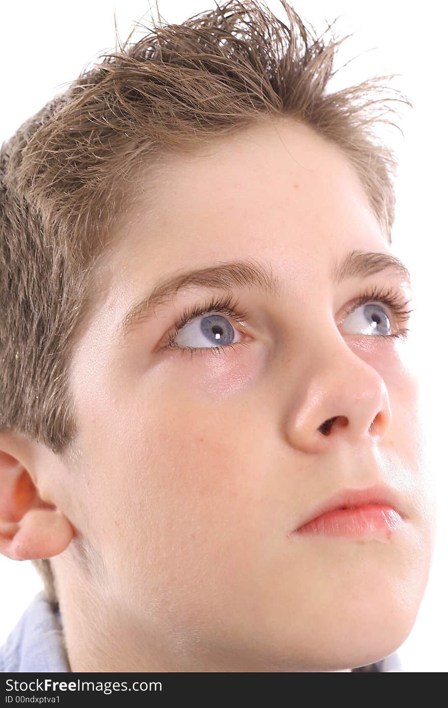 Photo of a blue eyed boy thinking upclose