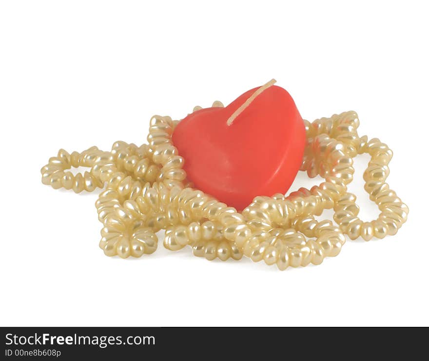 Red candle and necklace of artificial pearls, isolated on white. Red candle and necklace of artificial pearls, isolated on white.