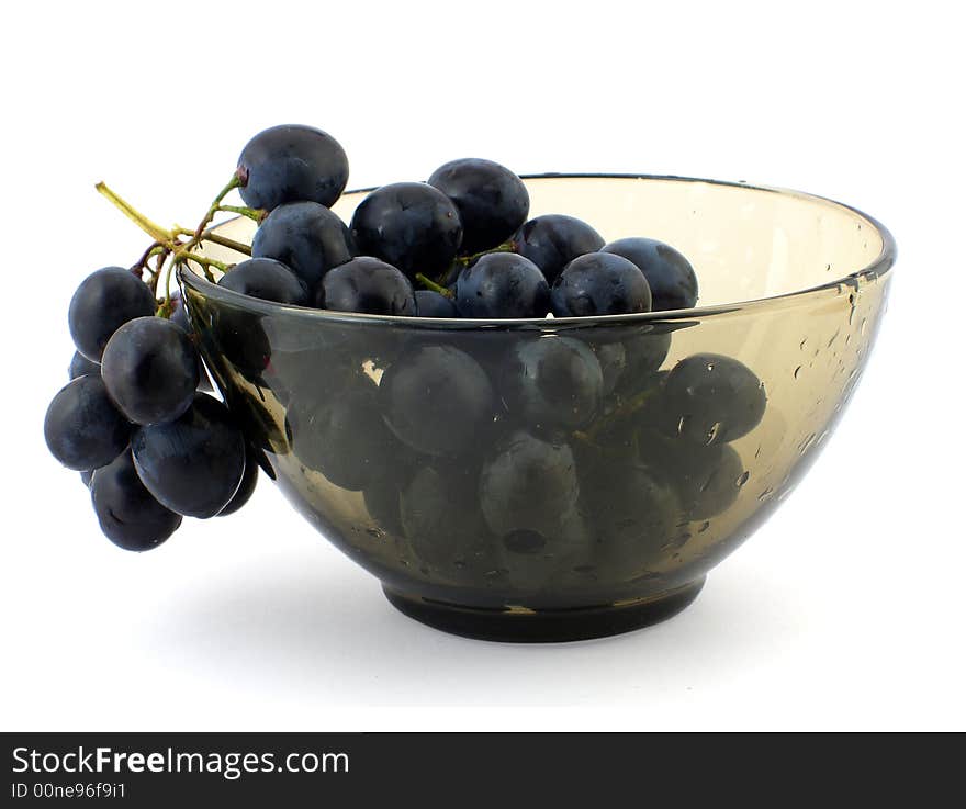 Cluster of grapes in wet glass bowl, isolated on white. Cluster of grapes in wet glass bowl, isolated on white.