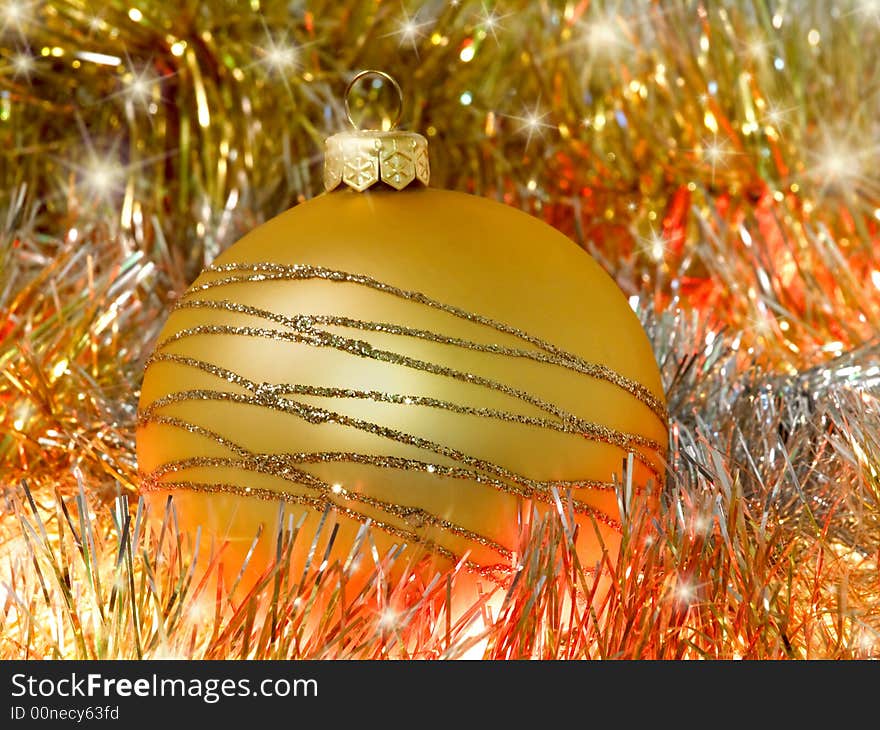 Yellow christmas decoration ball on bright background