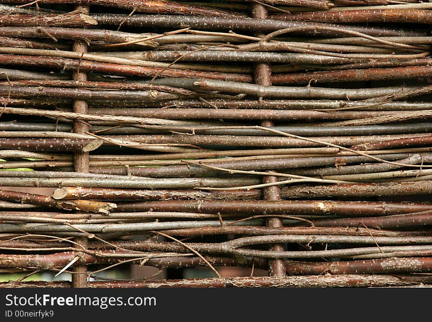 Woven wooden willow fencing in horizontal lines.