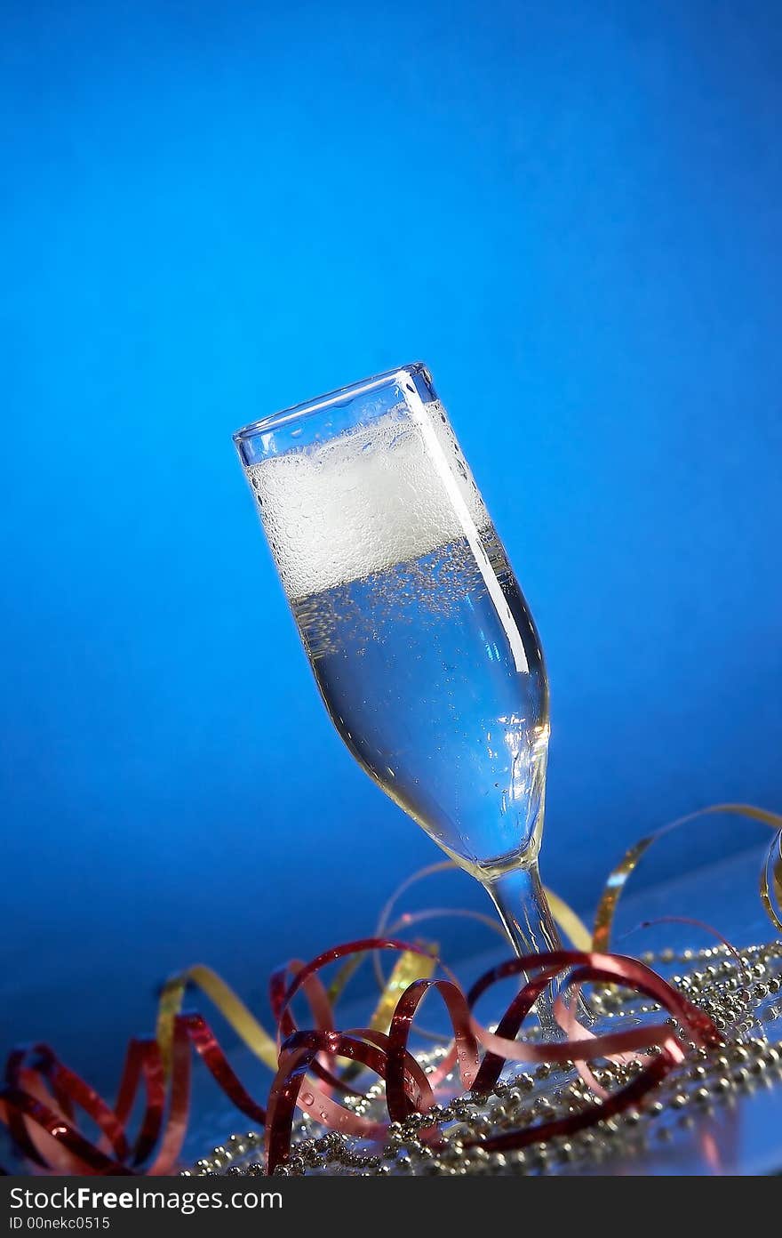 Still life with glass with champagne on the blue background