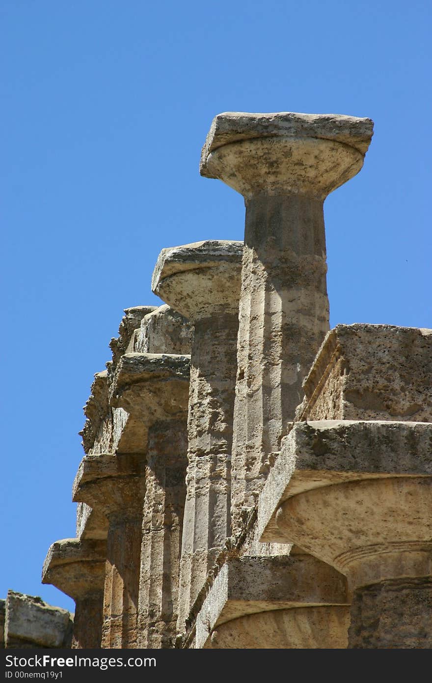 Pillars of Peastum in front of a blue sky. Pillars of Peastum in front of a blue sky