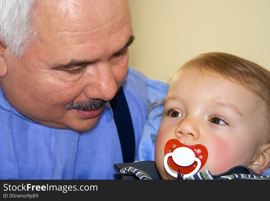 Grandfather grandson forehead over yellow background