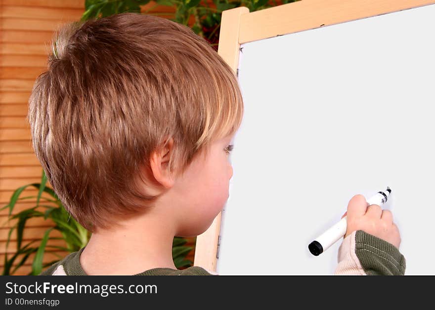 The boy drawing on a board