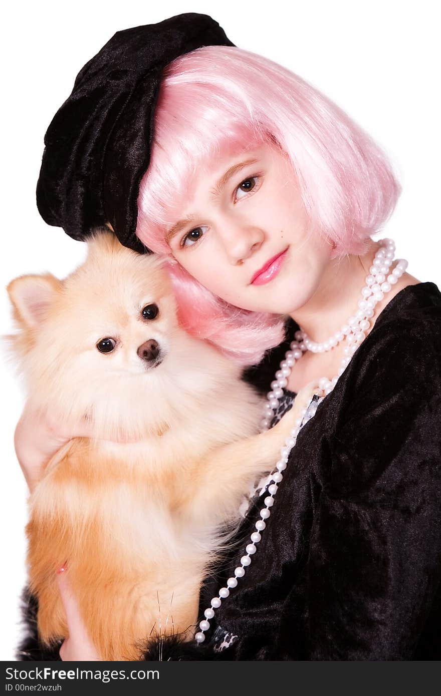 Pretty preteen diva with pink hair snuggling with her Pomeranian puppy. Pretty preteen diva with pink hair snuggling with her Pomeranian puppy.