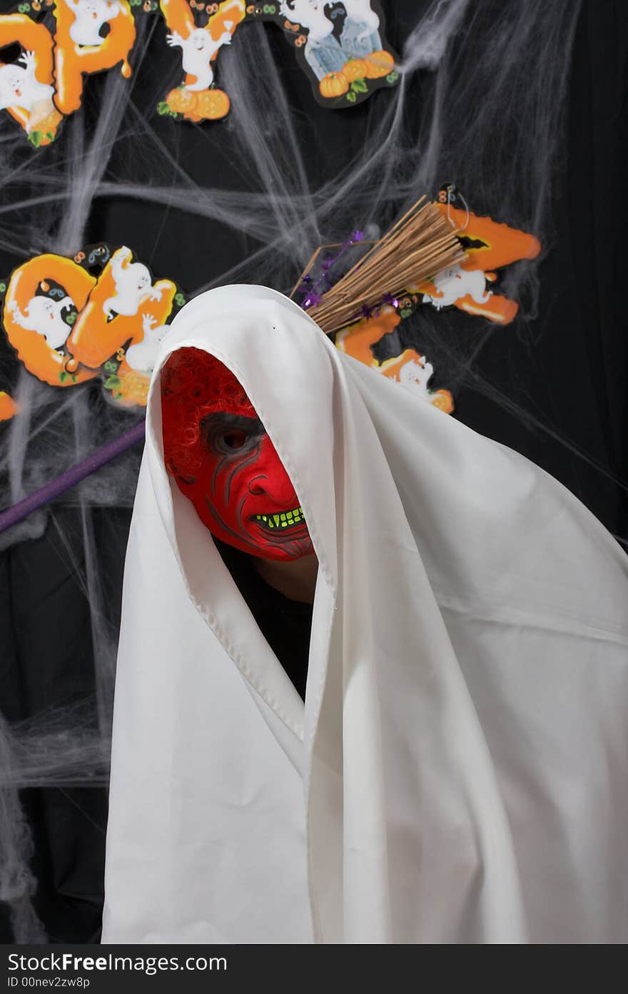 A man wearing a scary mask over a halloween background