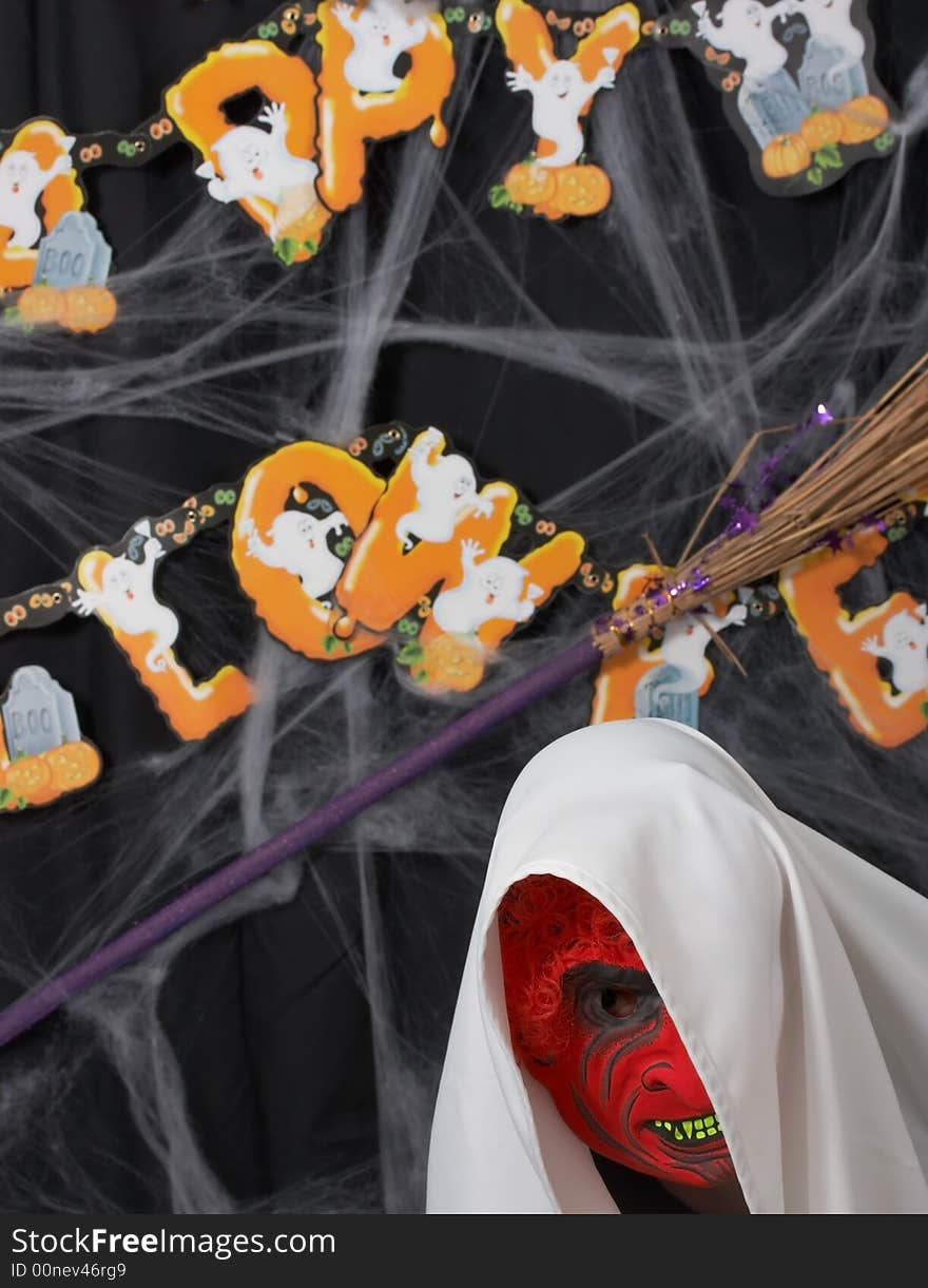 A man wearing a scary mask over a halloween background