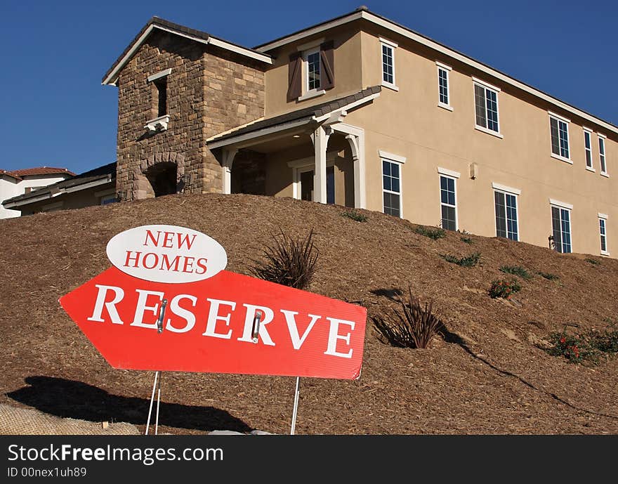 New Home Reserve Sign in Front of New House. New Home Reserve Sign in Front of New House.