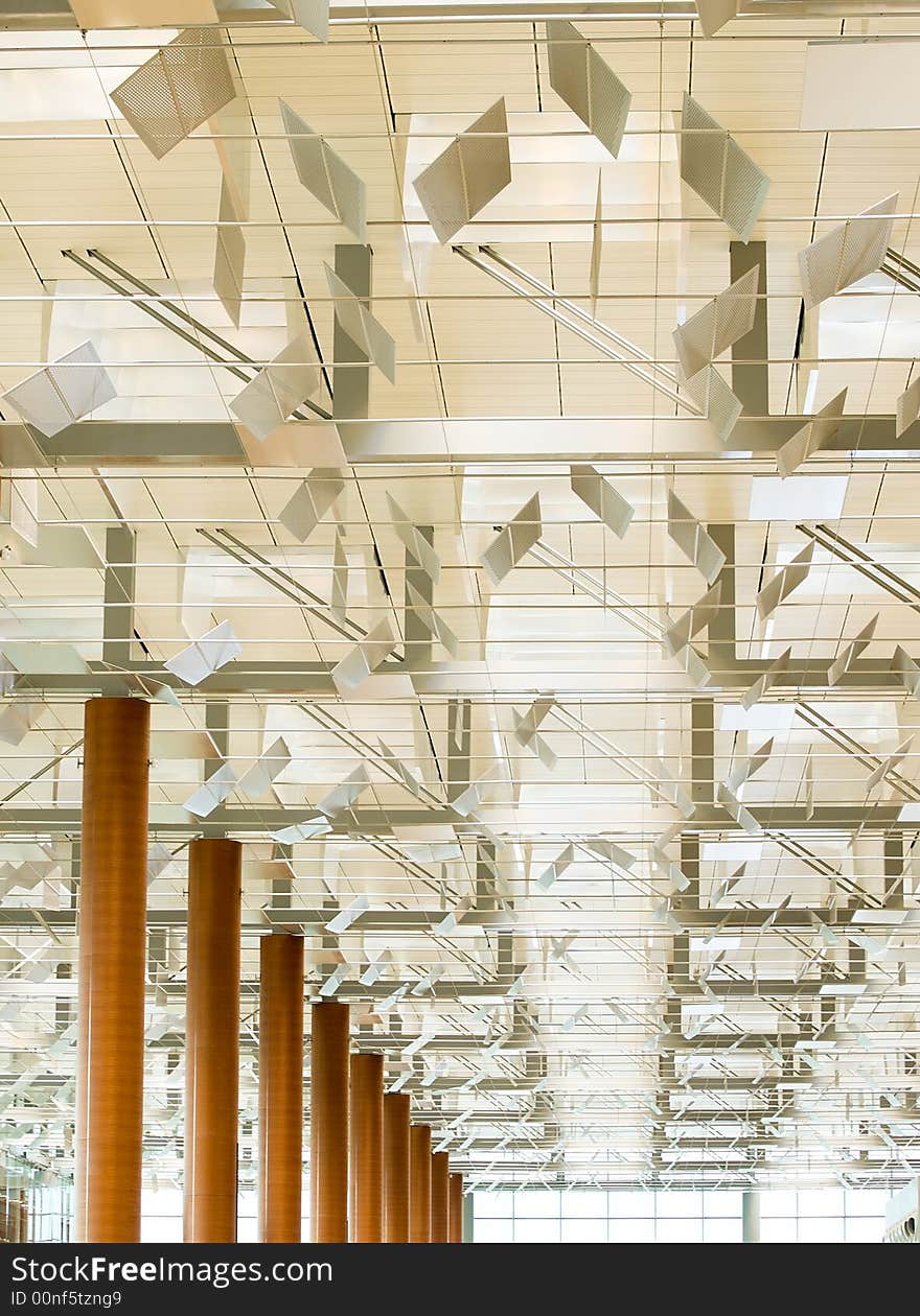 Modern Ceiling with baffles that regulate the diffusion of light in the departure hall of a modern airport. Modern Ceiling with baffles that regulate the diffusion of light in the departure hall of a modern airport