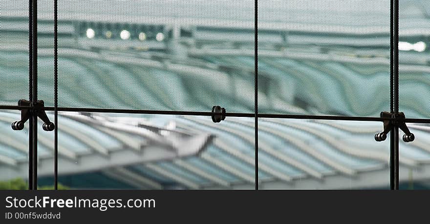 Distortion due to diffraction through a fine metallic mesh shielding the glass panels of a building's glass walls as seen from the interior