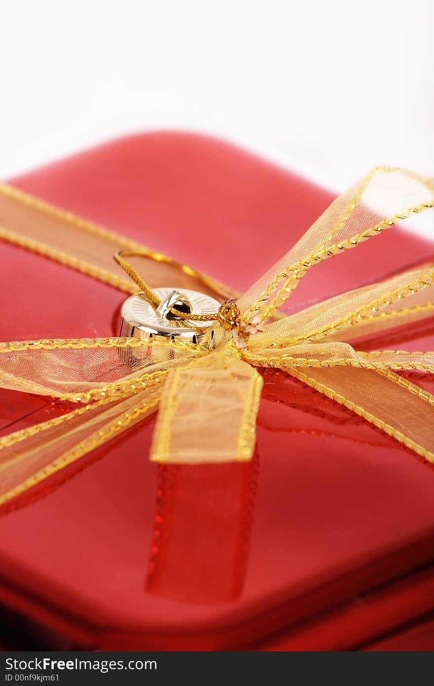 A gift wrapped in yellow and red on a white background