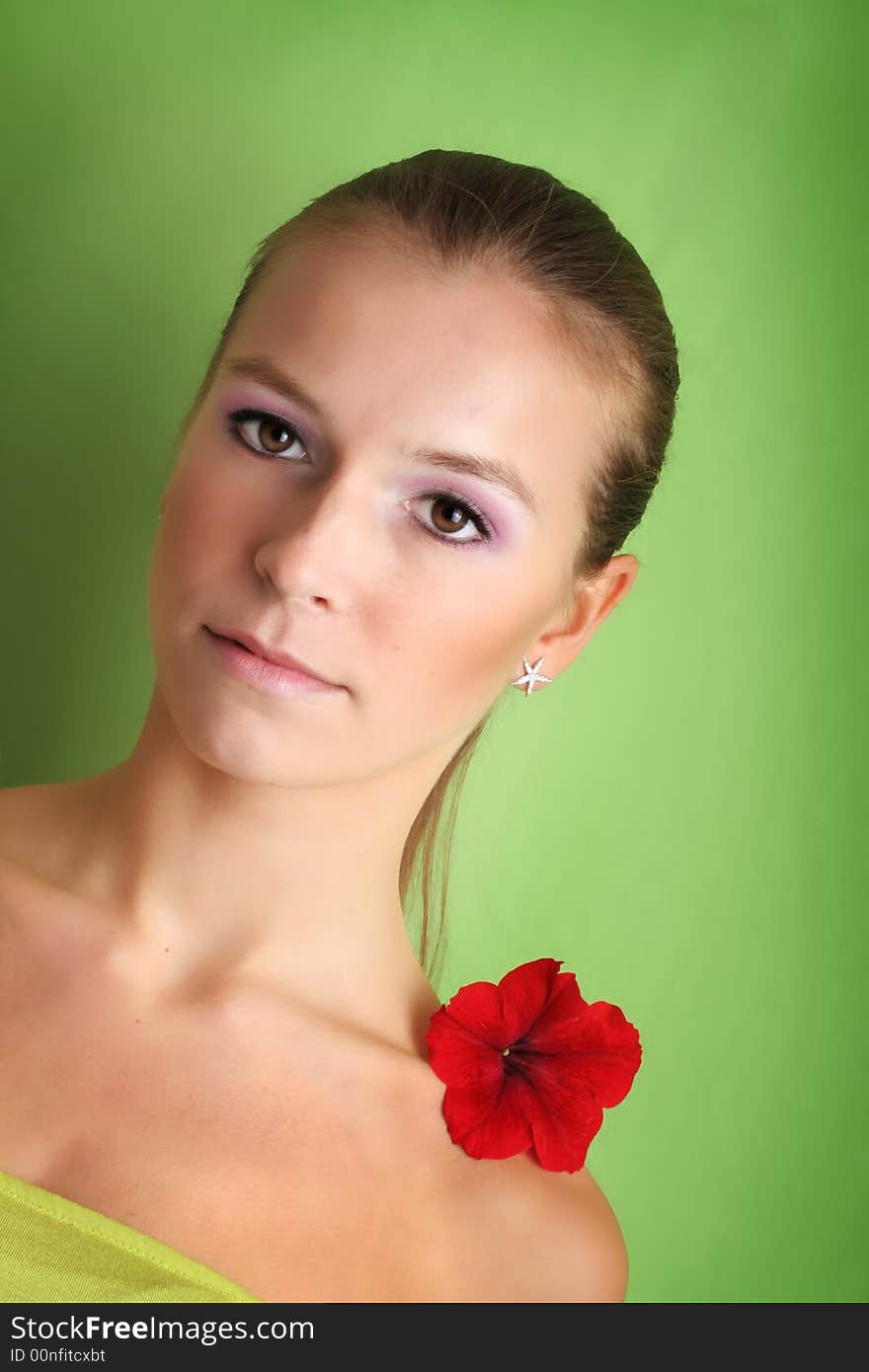 Beauty portrait of a beautiful young woman with a flower on her face. Beauty portrait of a beautiful young woman with a flower on her face