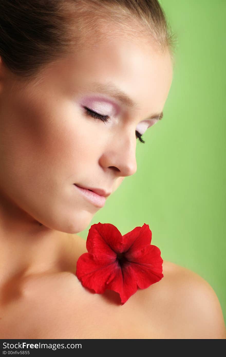 Beauty portrait of a beautiful young woman with a flower on her face. Beauty portrait of a beautiful young woman with a flower on her face