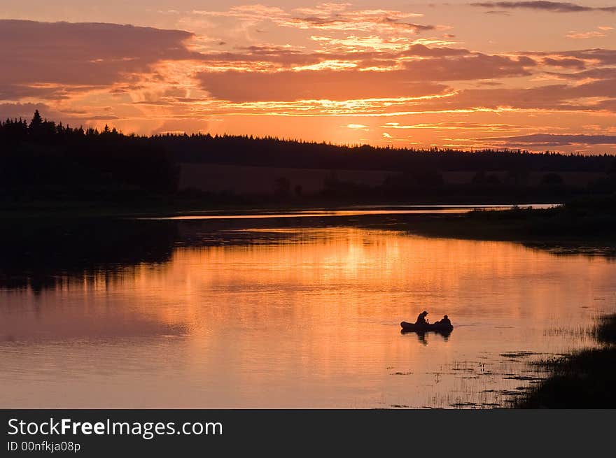 Fishermen in the lake on the sunset. Fishermen in the lake on the sunset