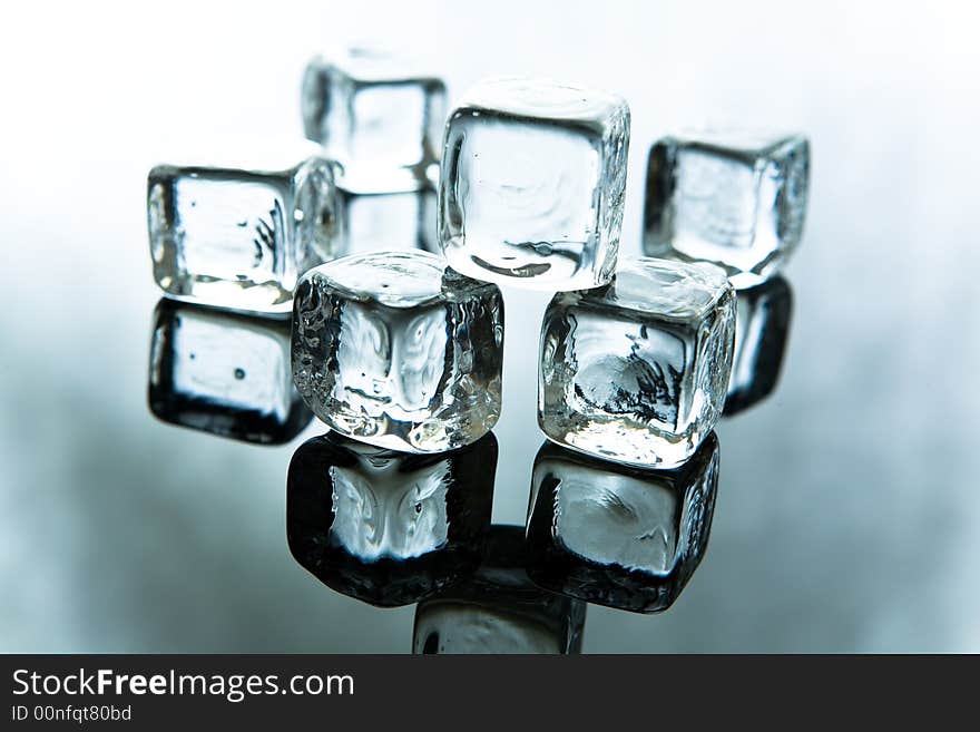 Melting ice cubes ob blue background